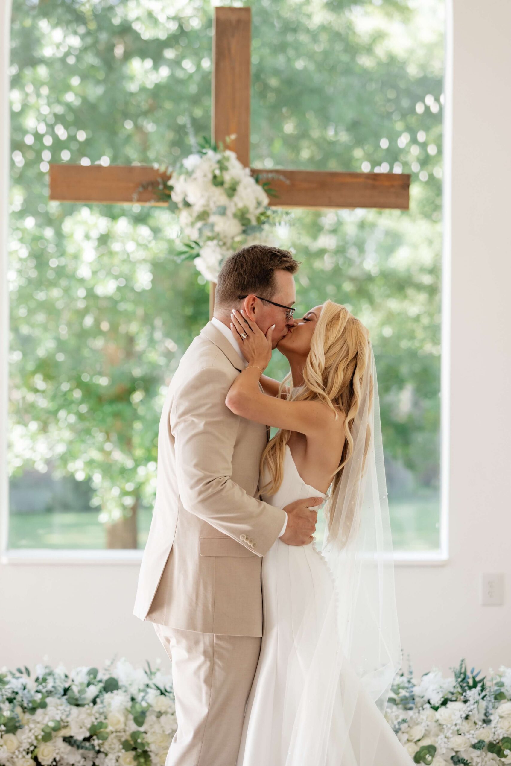 Hannah and Michael kissing during their Whitewood Ranch wedding ceremony