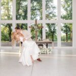 Hannah and Michael performing a dip during their coordinated first dance at Whitewood Ranch