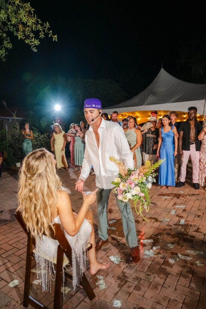 Emily watches Aaron perform One Less Lonely Girl during their Lakeview Gardens wedding reception.