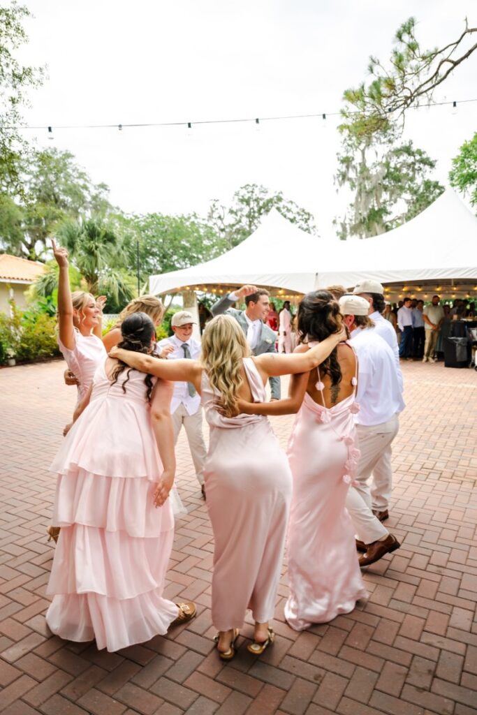 Guests pack the dance floor during Emily and Aaron's high-energy Lakeview Gardens wedding reception.