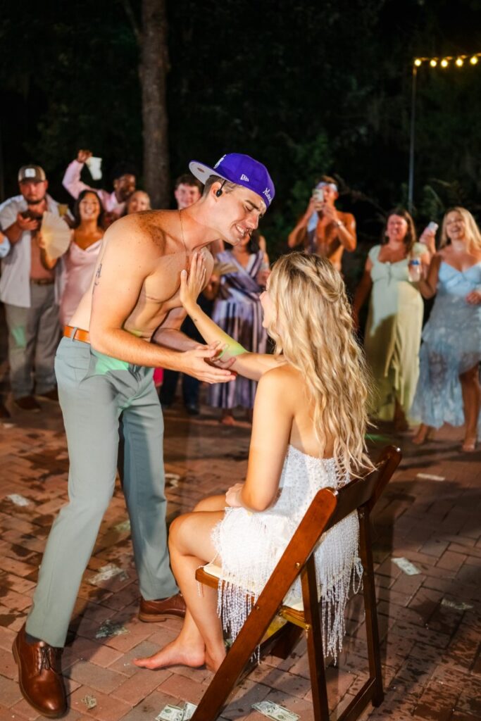 Aaron holds flowers while performing his Justin Bieber inspired wedding surprise for Emily at Lakeview Gardens.
