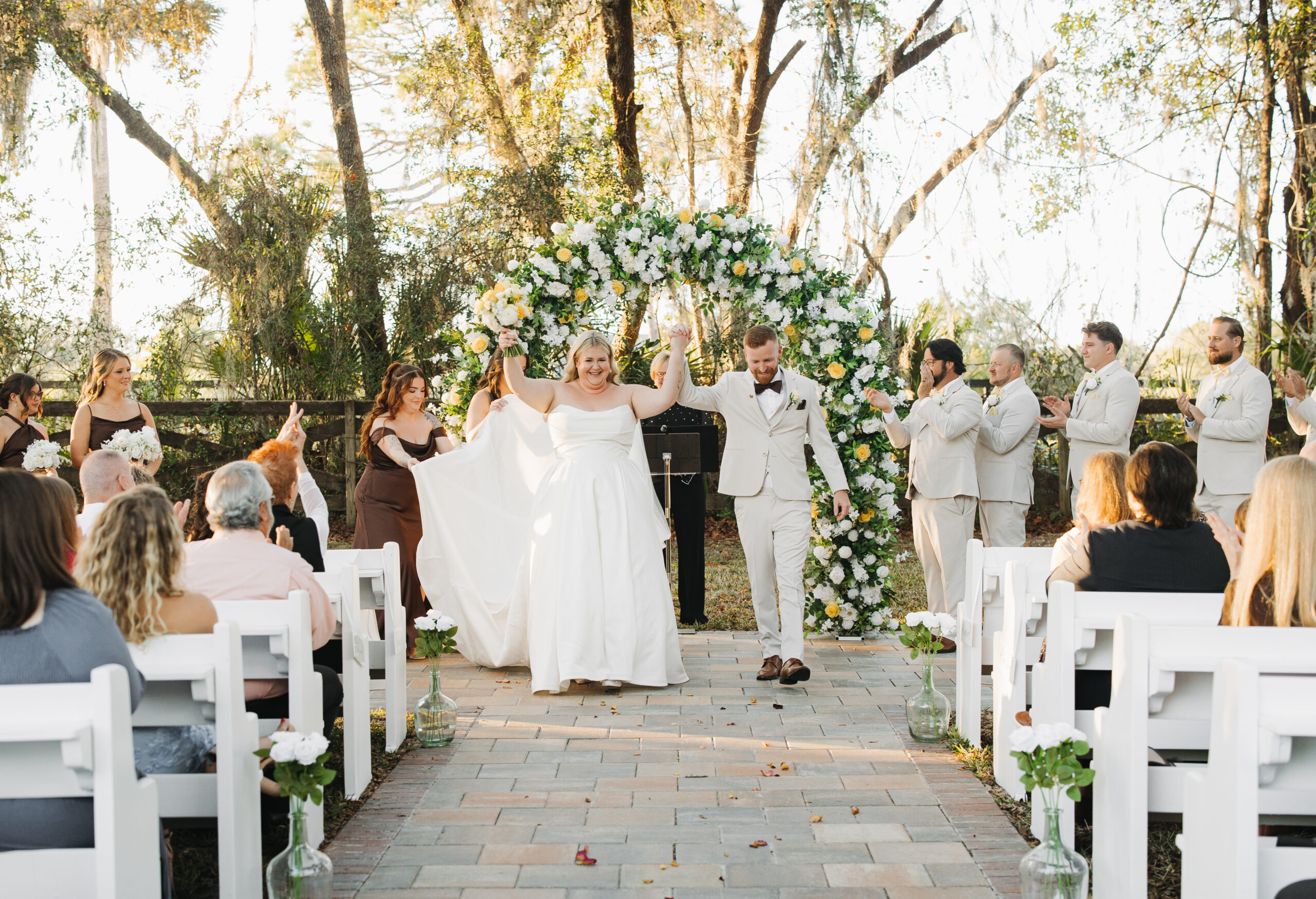 Newlyweds Travis and Sydney celebrating after their outdoor wedding ceremony at The Farmhouse on 44.