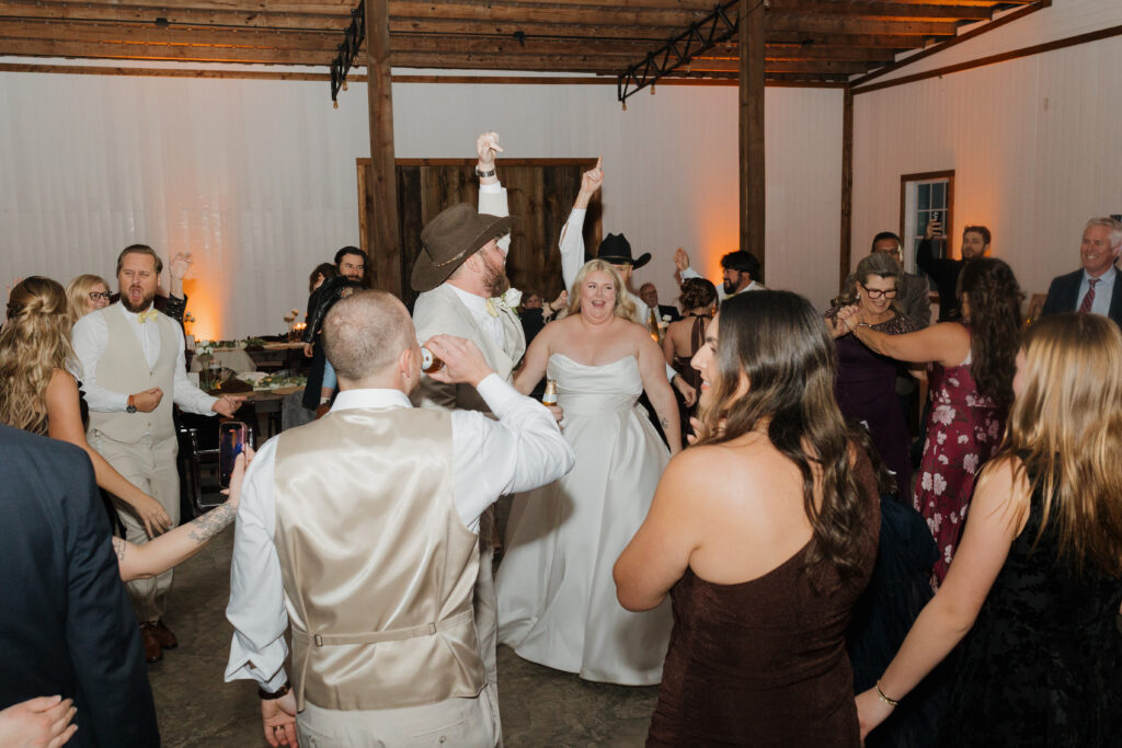 Travis, Sydney and their wedding guests dancing during the reception with Party Springs Entertainment.