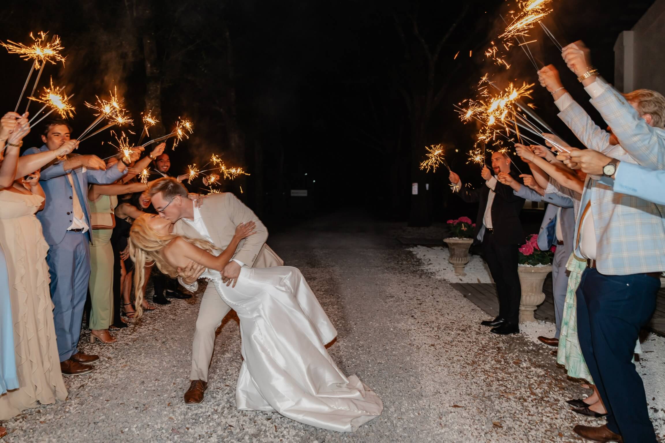 Hannah and Michael kissing beneath sparklers at the end of their wedding