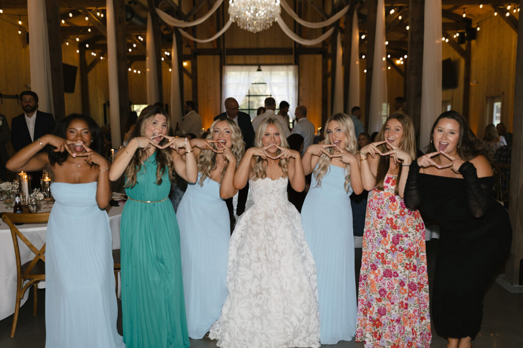 Bride celebrating with friends during The Barn at Hidden Oaks wedding reception