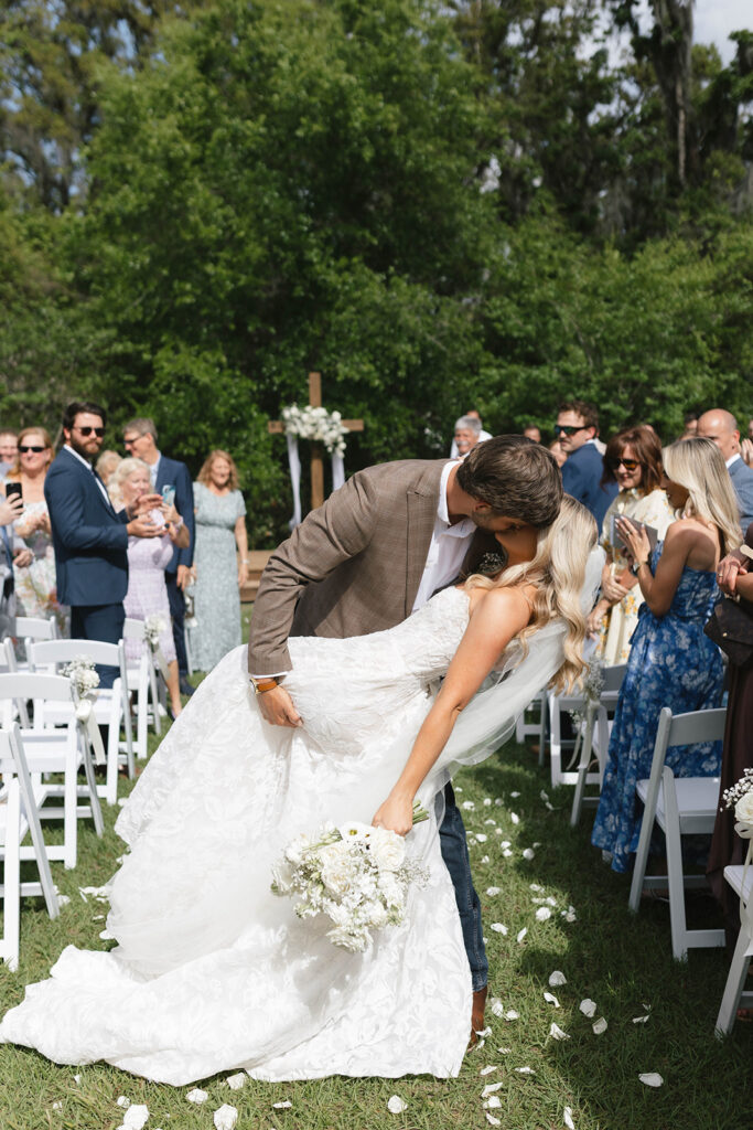 Sierra and Marshall kiss during their Lake Mary wedding ceremony