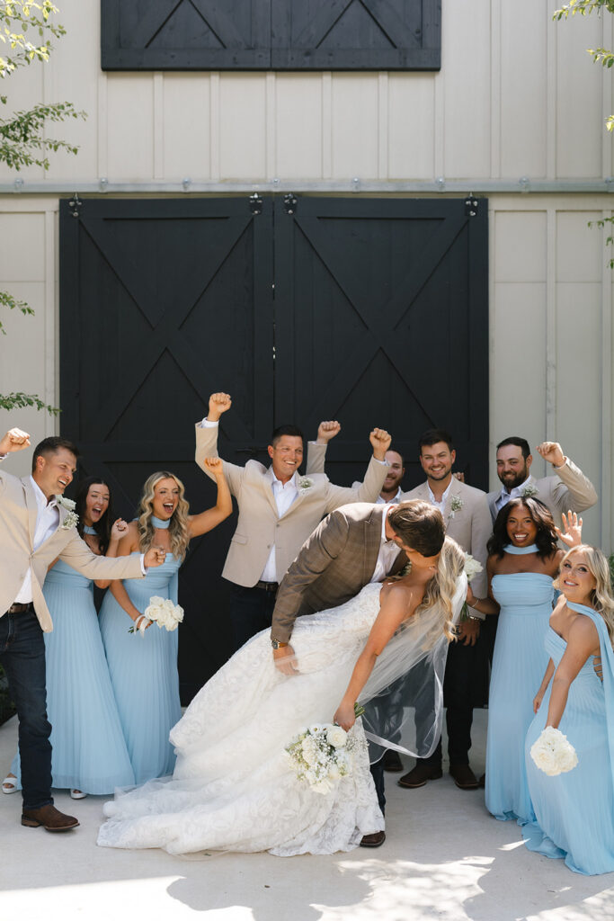 Bride celebrating with the wedding party at The Barn at Hidden Oaks reception