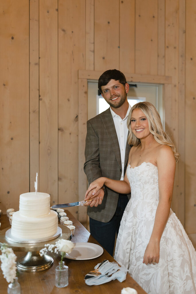 Sierra and Marshall cut their wedding cake at The Barn at Hidden Oaks