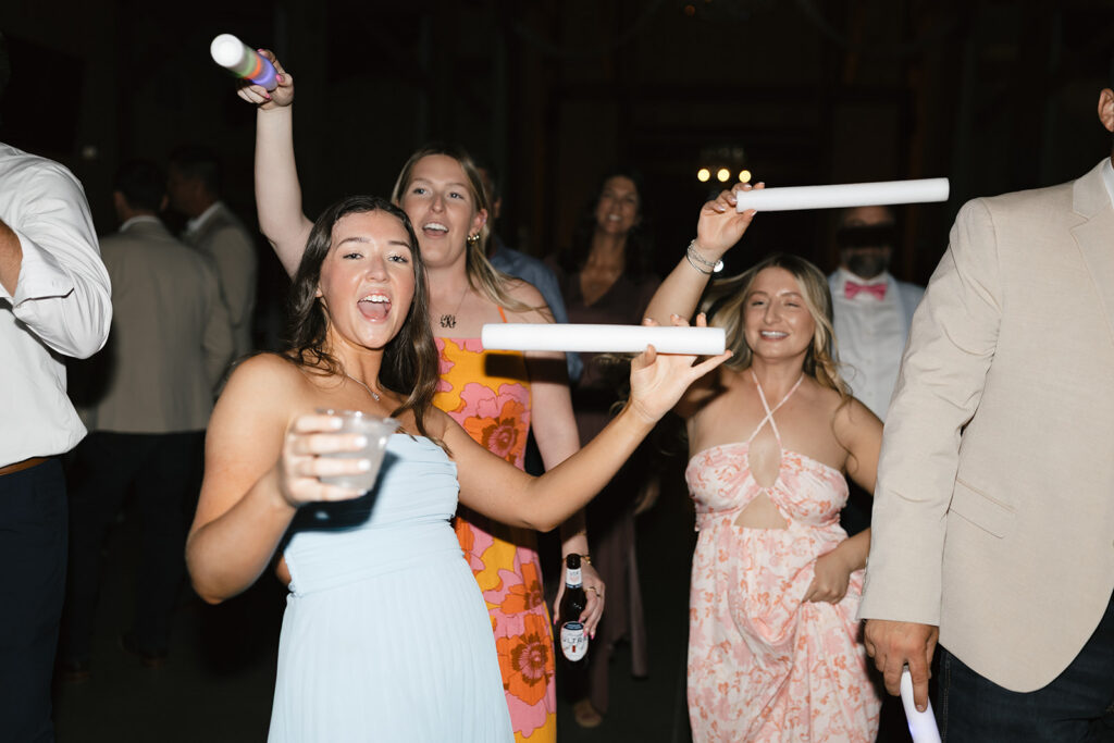 Wedding guests dancing with glow sticks at a Lake Mary reception
