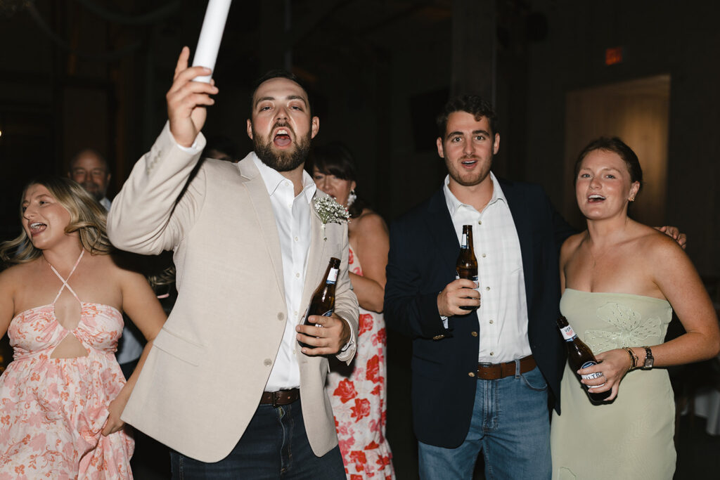 Wedding guests celebrating on the dance floor at The Barn at Hidden Oaks